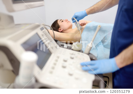 Mammologist doctor examines a woman breasts and lymph nodes using ultrasound. Mammography and ultrasound scanning are main methods of instrumental diagnosis of mammary glands. Breast cancer 120351279