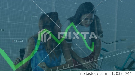 Analyzing financial data, two women working over stock market graph image Analyzing financial data, two women working over stock market graph image 120351744