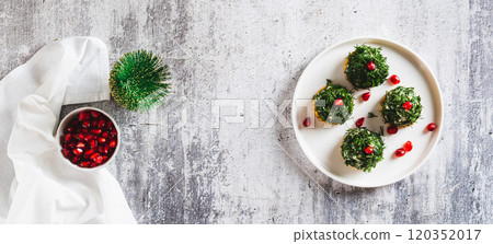Fish salad in dill on crackers in the shape of Christmas trees on a plate top view web banner Fish salad in dill on crackers in the shape of Christmas trees on a plate top view web banner 120352017