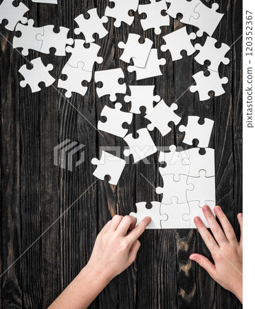 hands starting to collect puzzle pieces hands starting to collect puzzle pieces 120352367