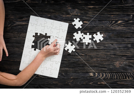 hands starting to collect puzzle pieces hands starting to collect puzzle pieces 120352369