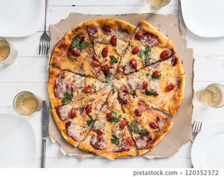 table with pizza set for four persons 120352372