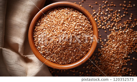 Close-up view of mustard seeds in a wooden bowl on a dark wooden table. Top view. Ideal for culinary and food-related content 120352573
