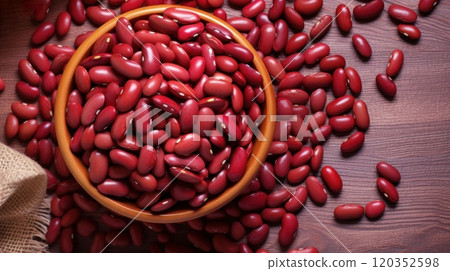 Raw Red kidney beans in a wooden bowl on a wooden table, top view. Ideal for food and cooking related content. For banner, poster, advertising, web design, organic food store, supermarket, food blog Raw Red kidney beans in a wooden bowl on a wooden table, top view. Ideal for food and cooking related content. For banner, poster, advertising, web design, organic food store, supermarket, food blog 120352598
