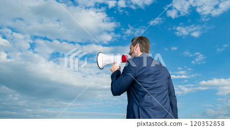 back view of businessman shout in loudspeaker on sky background. copy space 120352858