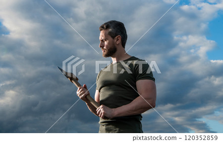 man with axe. caucasian man hold ax. brutal man on dramatic sky background 120352859