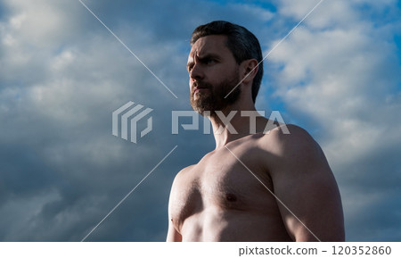 shirtless muscular man. caucasian man with muscular torso. athletic man on sky background. 120352860