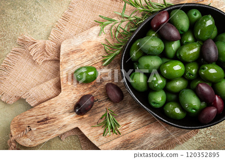 Chalkidiki olives, classic Greek green olives, in a bowl on a cutting board, top view, without people, 120352895