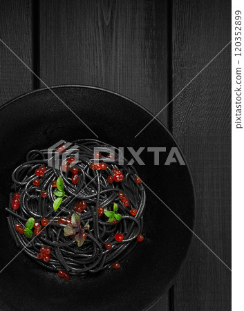 Black spaghetti with red caviar, pasta, on a black background, top view, no people, Black spaghetti with red caviar, pasta, on a black background, top view, no people, 120352899