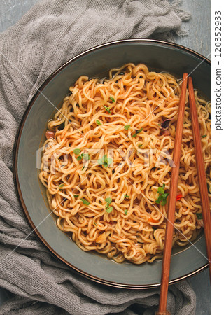 Instant noodles, in a bowl, on a gray table, top view, no people, 120352933
