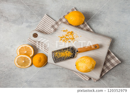 Grated lemon zest, on a cutting board, with a grater , top view, no people, 120352979