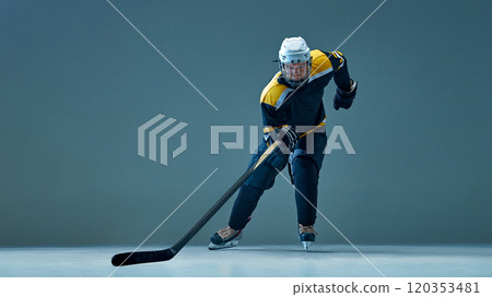 Dynamic image of man, professional ice hockey player in motion, wearing helmet and uniform, training before the game Dynamic image of man, professional ice hockey player in motion, wearing helmet and uniform, training before the game 120353481