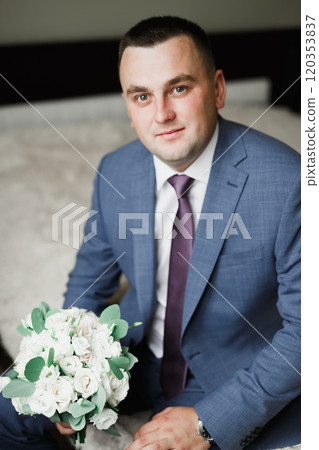 Beautiful man, groom holding big and beautiful wedding bouquet with flowers Beautiful man, groom holding big and beautiful wedding bouquet with flowers 120353837