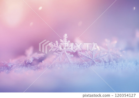 Delicate snowflakes sparkle on soft snow with a dreamy pastel background in a serene winter landscape at dusk 120354127