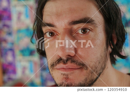 Man with tousled hair gazes thoughtfully into the distance amidst a lively atmosphere Man with tousled hair gazes thoughtfully into the distance amidst a lively atmosphere 120354910