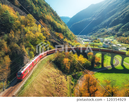 Aerial view of red train on Kreisviadukt Brusio in mountains Aerial view of red train on Kreisviadukt Brusio in mountains 120354929