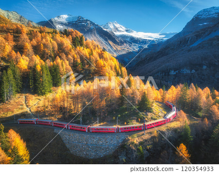 Bernina express train is moving along the swiss alps in autumn 120354933