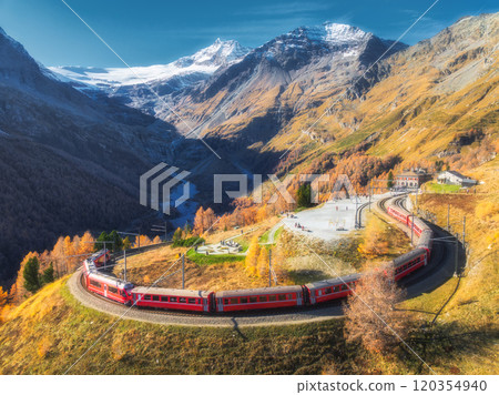 Bernina express train is moving along the swiss alps in autumn 120354940
