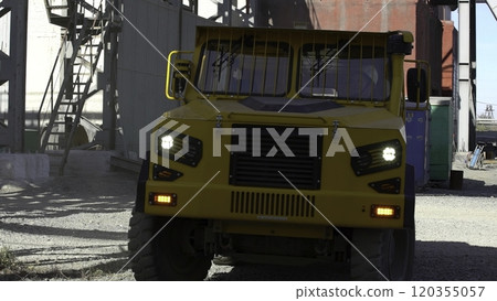 A Robust Heavy Duty Yellow Truck Operating Within a Challenging Industrial Setting. Stock Clip 120355057