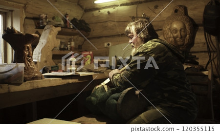 An Artisan Focuses on the Crafting of a Beautiful Wood Sculpture in a Rustic Workshop Setting. Stock Clip An Artisan Focuses on the Crafting of a Beautiful Wood Sculpture in a Rustic Workshop Setting. Stock Clip 120355115