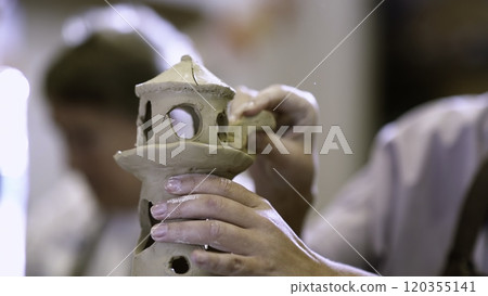 An Artisan Expertly Crafting a Beautiful and Decorative Ceramic Piece with Careful Detail. Stock Clip 120355141