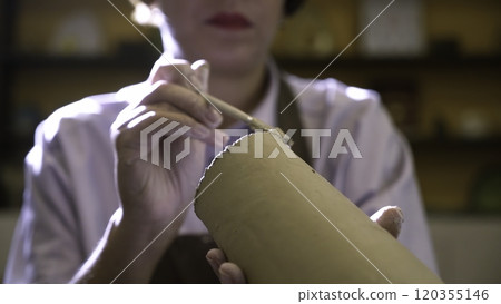 An Artisan Expert Focused on Crafting a Stunning Ceramic Piece with Skillful Precision. Stock Clip An Artisan Expert Focused on Crafting a Stunning Ceramic Piece with Skillful Precision. Stock Clip 120355146