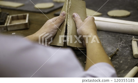 Creating a One of a Kind Unique Ceramic Piece in a Dedicated Artisan Workshop Environment. Stock Clip Creating a One of a Kind Unique Ceramic Piece in a Dedicated Artisan Workshop Environment. Stock Clip 120355185