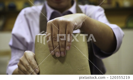 An Artisan Passionately Creating Unique and Beautiful Pottery with Clay in Their Workshop. Stock Clip An Artisan Passionately Creating Unique and Beautiful Pottery with Clay in Their Workshop. Stock Clip 120355219