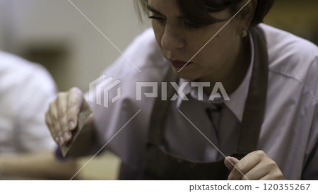 An Enthusiastic and Focused Artisan Engaged in Creative Culinary Work During a Class Setting. Stock Clip 120355267