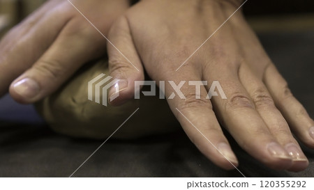 Hands are skillfully shaping clay in a pottery workshop where creativity blends with craft. Stock Clip 120355292