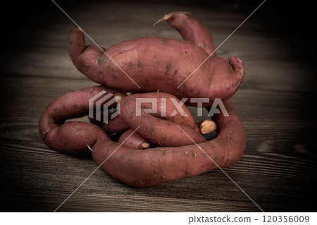 Sweet potatoes on the brown background  120356009