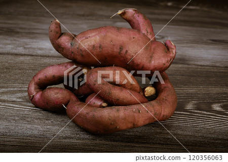 Sweet potatoes on the brown background Sweet potatoes on the brown background 120356063