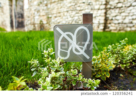 A do not walk sign is installed on the lawn. A do not walk sign is installed on the lawn. 120356241