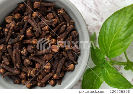 Organic cloves spice in a small bowl macro. 120356898