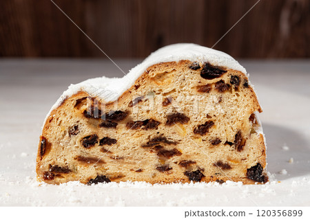 Cut in half stollen loaf on a table. Cut in half stollen loaf on a table. 120356899