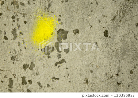 Textured Plaster Wall With Yellow Paint Splatter in a Rustic Setting 120356952