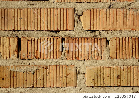 Light red brick masonry with vertical grooves. Rough gray cement seams. 120357018