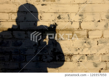 Silhouette shadow of a photographer man 120357050