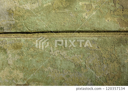 Wall cracked paint green yellow shades. Divided by a deep groove in the wall Wall cracked paint green yellow shades. Divided by a deep groove in the wall 120357134