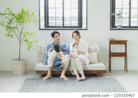 Young family, parents and children, living room Young family, parents and children, living room 120358467