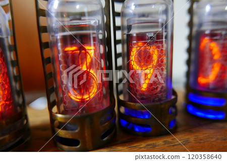 Retro Nixie lamp indicator clock on dark background. The Nixie tube indicator of the numbers of retro style. Retro Nixie lamp indicator clock on dark background. The Nixie tube indicator of the numbers of retro style. 120358640