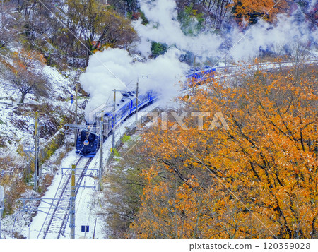 A steam locomotive running through autumn leaves A steam locomotive running through autumn leaves 120359028