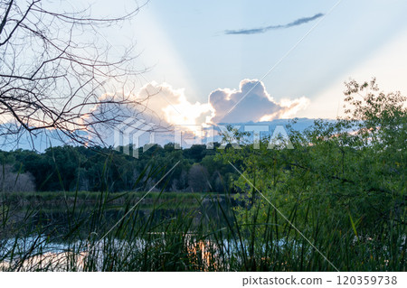 A stunning sunset and God's rays over a local MN lake with lots of greenery. A stunning sunset and God's rays over a local MN lake with lots of greenery. 120359738