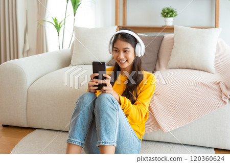 Happy young asian woman relaxing at home Happy young asian woman relaxing at home 120360624