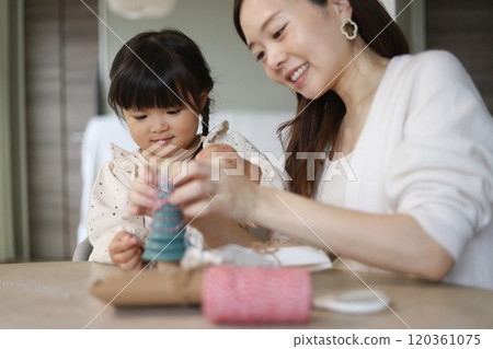 Parents and children decorating a small Christmas tree Parents and children decorating a small Christmas tree 120361075