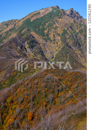 A hut with autumn leaves seen from Mt. Tanigatake A hut with autumn leaves seen from Mt. Tanigatake 120361290