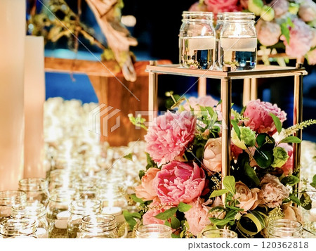 A beautiful combination of candles and flowers A beautiful combination of candles and flowers 120362818