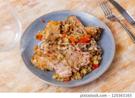 Traditional pearl barley porridge with stewed vegetables and fried rabbit on plate Traditional pearl barley porridge with stewed vegetables and fried rabbit on plate 120363165