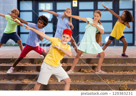 Children exercising contemporary dance moves outdoors Children exercising contemporary dance moves outdoors 120363231