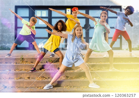 Children exercising contemporary dance moves outdoors Children exercising contemporary dance moves outdoors 120363257